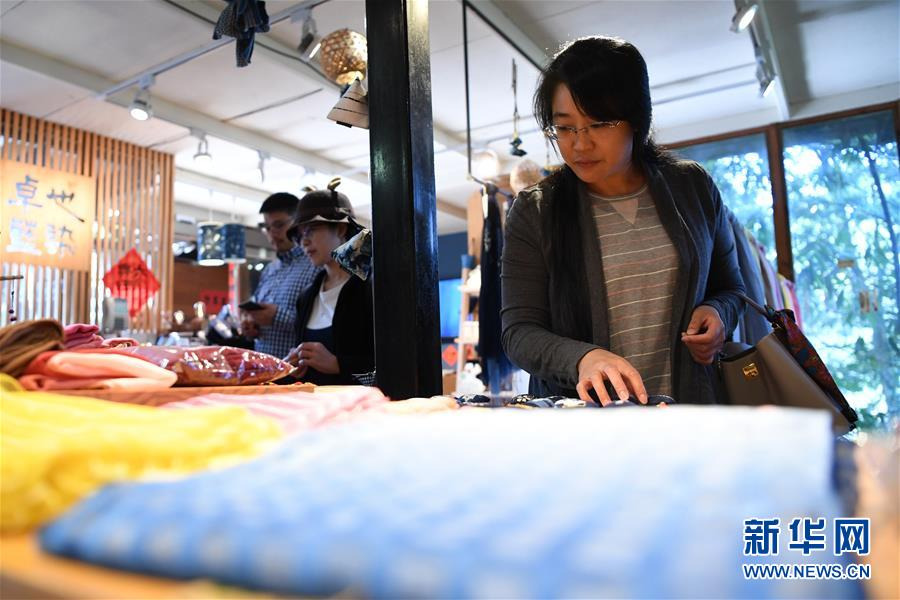 顧客在鄭美淑開辦的“卓也小屋”染布工坊挑選藍染商品（11月14日）。 新華社記者 陳斌 攝